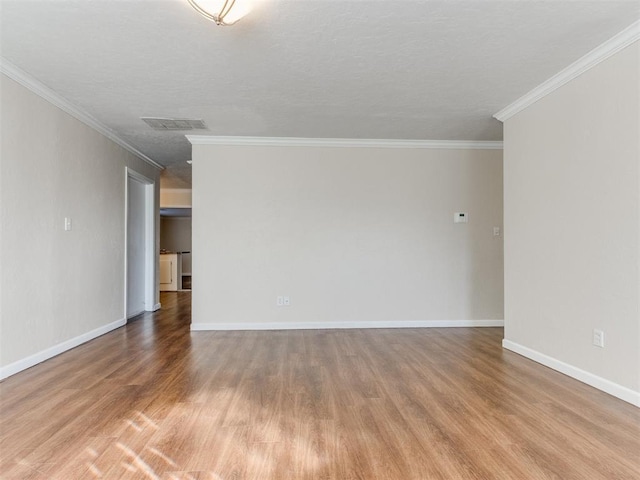 unfurnished room with crown molding, a textured ceiling, and hardwood / wood-style flooring