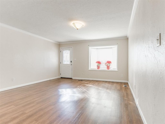 spare room with wood-type flooring and ornamental molding