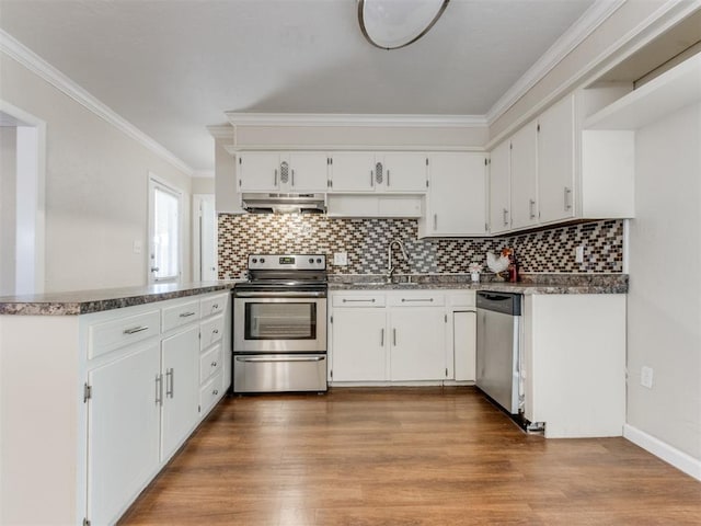 kitchen featuring appliances with stainless steel finishes, hardwood / wood-style flooring, white cabinetry, and sink