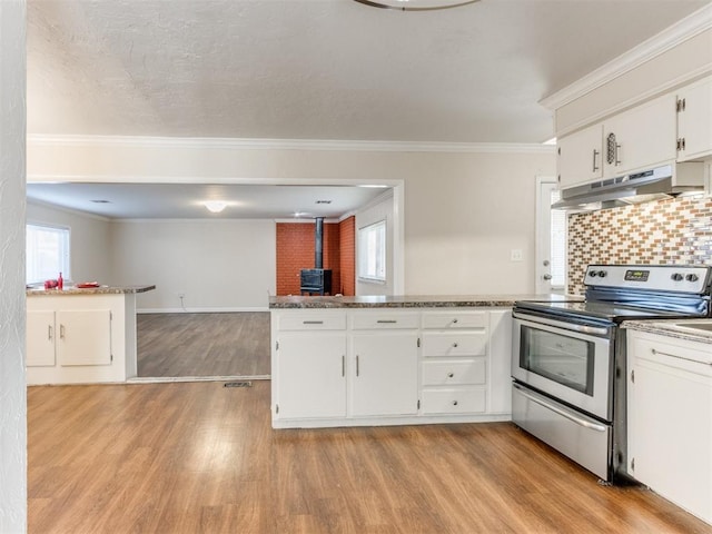 kitchen featuring light hardwood / wood-style floors, plenty of natural light, white cabinetry, and electric stove