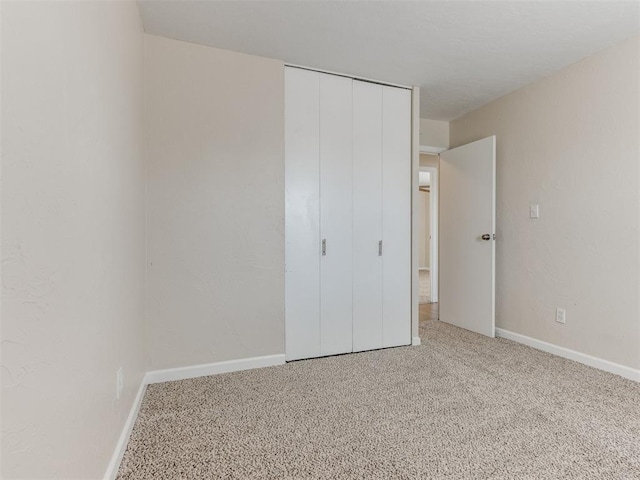 unfurnished bedroom with carpet and a closet