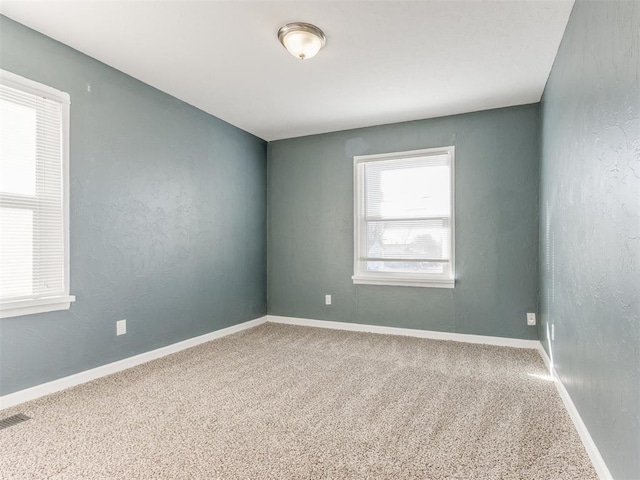 spare room featuring carpet floors