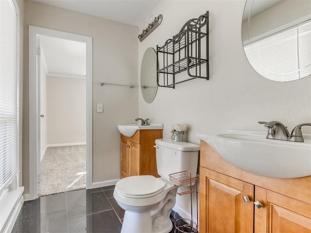 bathroom featuring tile patterned flooring, vanity, and toilet