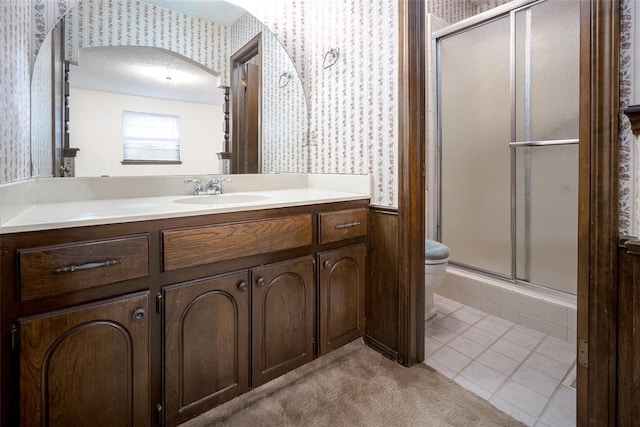 bathroom featuring tile patterned flooring, vanity, toilet, and a shower with shower door