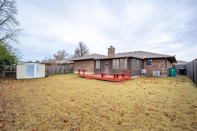 back of house featuring a yard, central AC, a shed, and a wooden deck