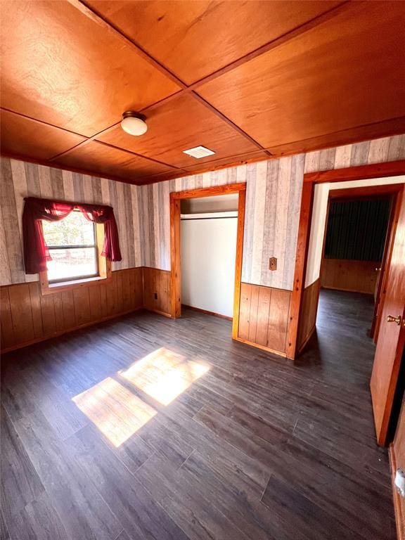 interior space featuring dark wood-type flooring, wooden ceiling, and wood walls