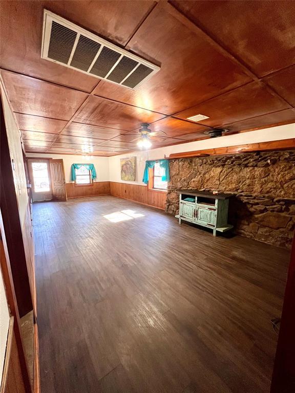 additional living space with wood ceiling, wood walls, and hardwood / wood-style flooring