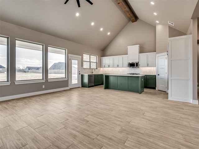 kitchen featuring high vaulted ceiling, white cabinets, green cabinetry, appliances with stainless steel finishes, and beam ceiling