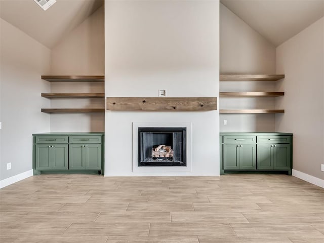 unfurnished living room with high vaulted ceiling