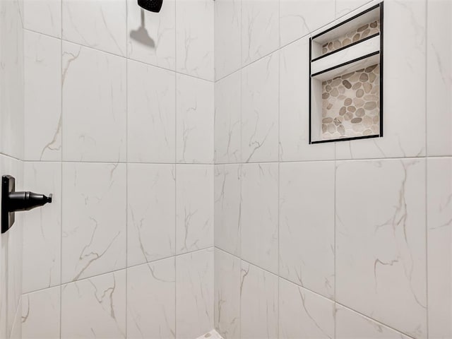 bathroom with a tile shower