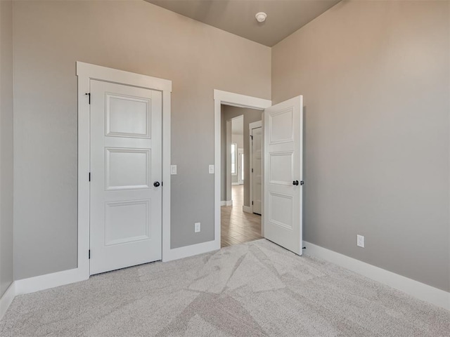 unfurnished bedroom featuring light carpet