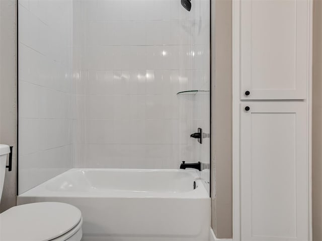 bathroom with tiled shower / bath combo and toilet