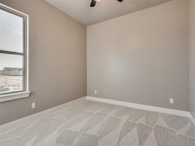 unfurnished room with ceiling fan and carpet floors