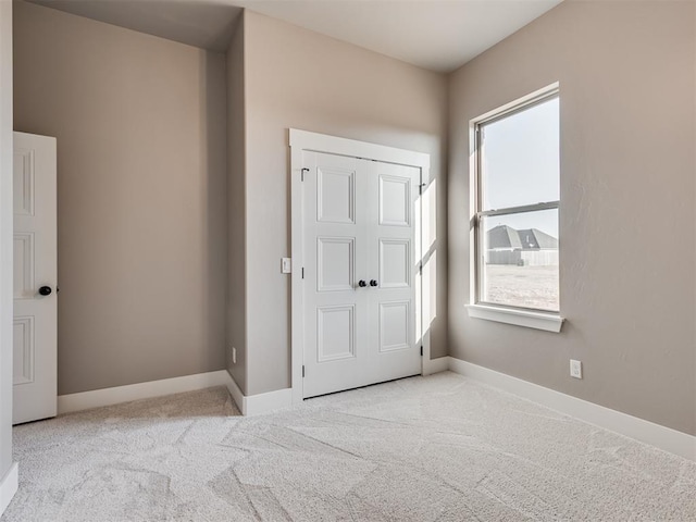 carpeted foyer entrance featuring plenty of natural light