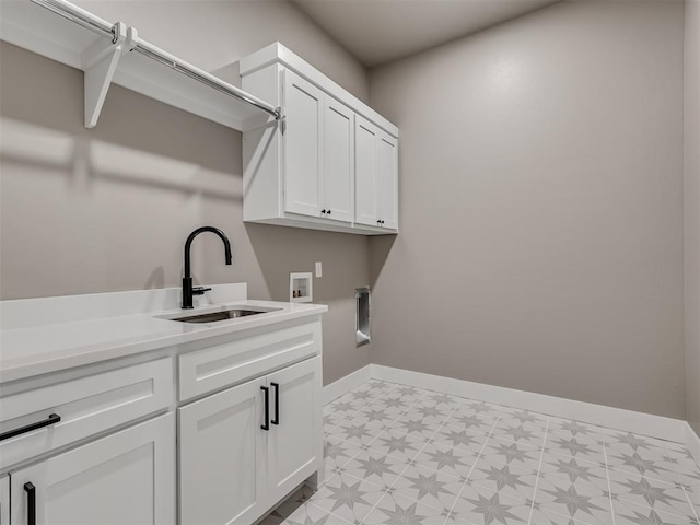 washroom featuring hookup for an electric dryer, sink, cabinets, and washer hookup