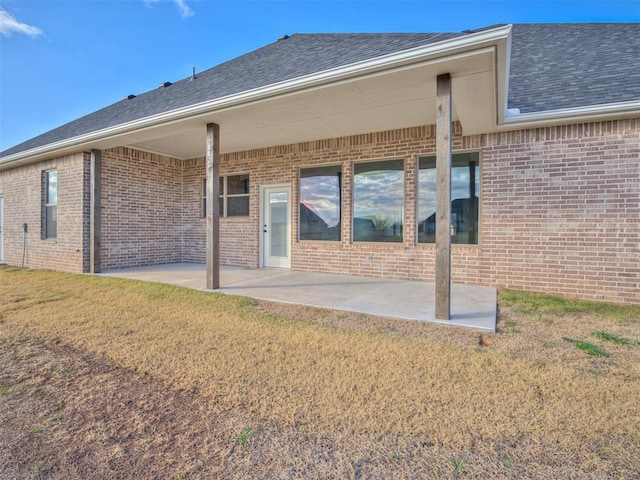 back of house with a yard and a patio area