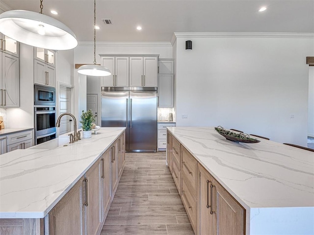 kitchen featuring a large island, pendant lighting, and appliances with stainless steel finishes