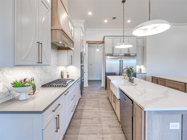 kitchen featuring white cabinetry, built in appliances, a large island, and custom range hood