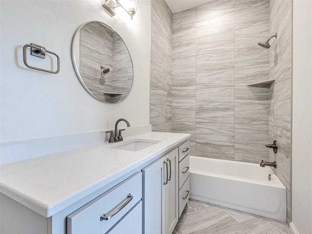 bathroom with vanity and tiled shower / bath combo