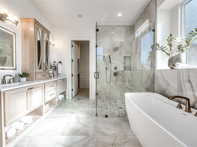 bathroom featuring vanity and shower with separate bathtub