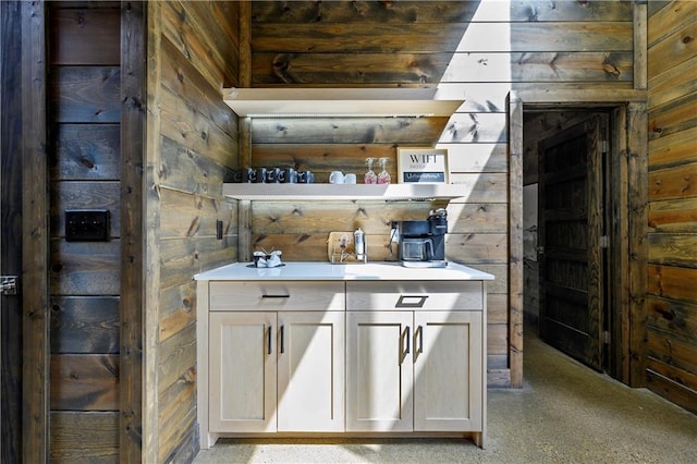 bar with wood walls and white cabinets