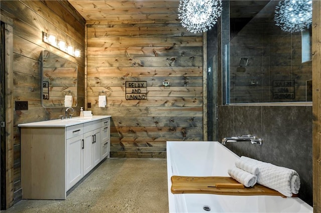 bathroom with a bathing tub, wood walls, and vanity