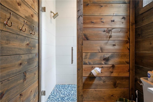 bathroom with walk in shower and wooden walls