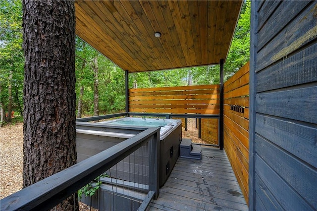 wooden terrace featuring a hot tub