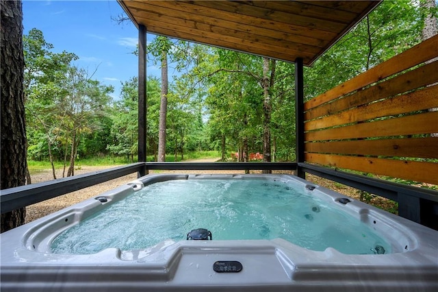 view of swimming pool featuring a hot tub