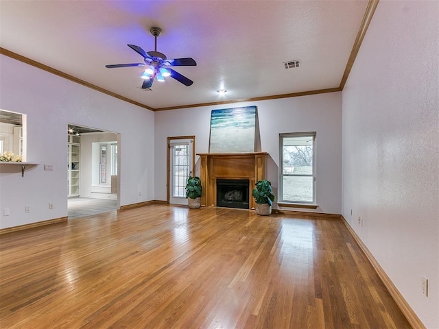 unfurnished living room with crown molding, ceiling fan, and light hardwood / wood-style flooring