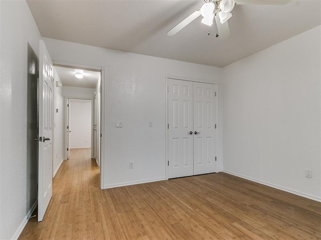 unfurnished bedroom featuring light hardwood / wood-style floors, a closet, and ceiling fan