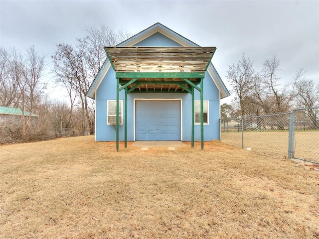 exterior space with a garage and a lawn