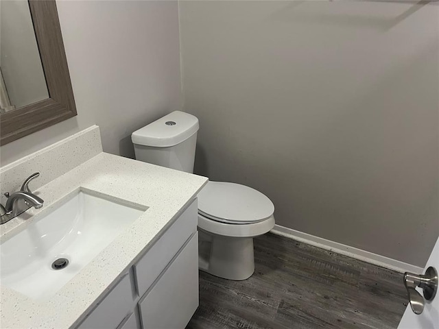 bathroom featuring hardwood / wood-style floors, vanity, and toilet