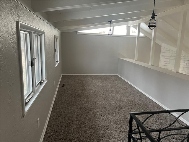 carpeted spare room featuring lofted ceiling with beams