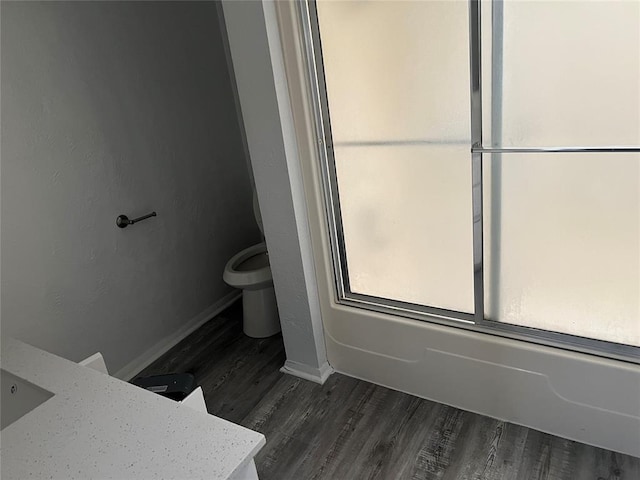 bathroom with hardwood / wood-style floors, vanity, and toilet