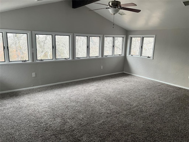 carpeted spare room featuring vaulted ceiling with beams, ceiling fan, and plenty of natural light