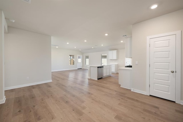 5408 Windstone Ln, Norman, OK 73072 - unfurnished living room featuring light wood-type flooring, baseboards, recessed lighting, and visible vents