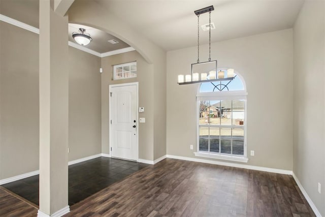 foyer featuring dark hardwood / wood-style floors and ornamental molding