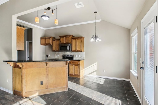 kitchen with kitchen peninsula, plenty of natural light, hanging light fixtures, and lofted ceiling