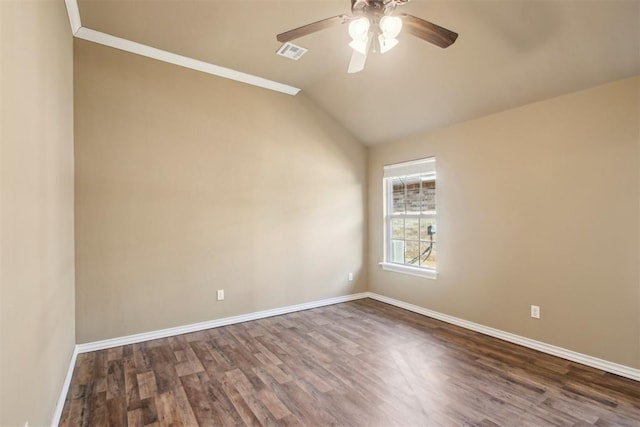 spare room with ceiling fan, dark hardwood / wood-style flooring, ornamental molding, and vaulted ceiling