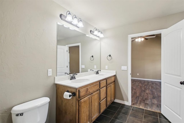 bathroom featuring tile patterned floors, vanity, and toilet