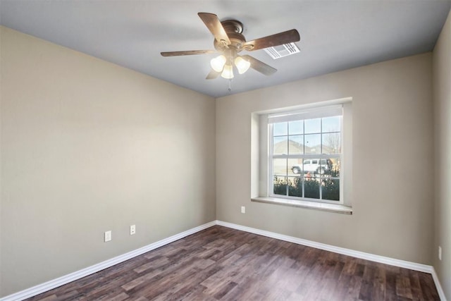 empty room featuring ceiling fan and dark wood-type flooring