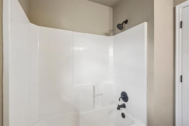 bathroom with bathing tub / shower combination