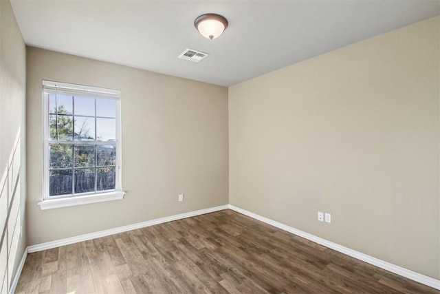 spare room with wood-type flooring