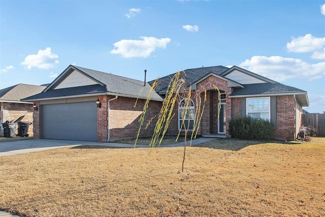 view of front of property featuring a front yard and a garage