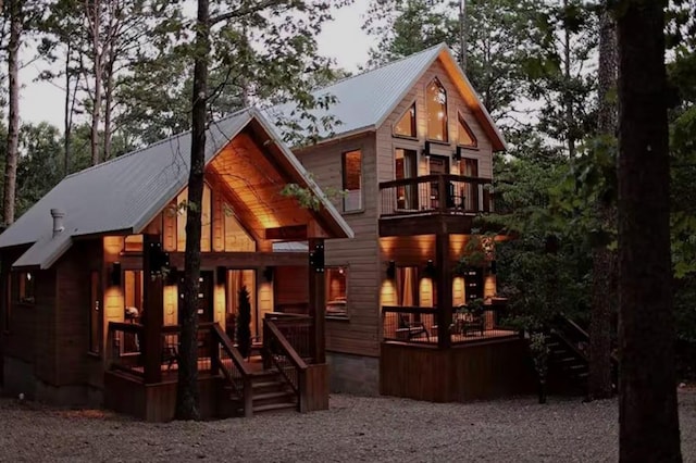 rear view of property with a balcony