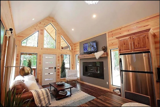 living room featuring plenty of natural light, high vaulted ceiling, and dark wood-type flooring