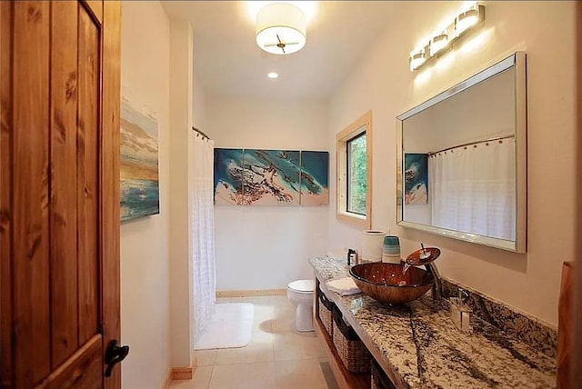 bathroom with tile patterned floors, vanity, and toilet