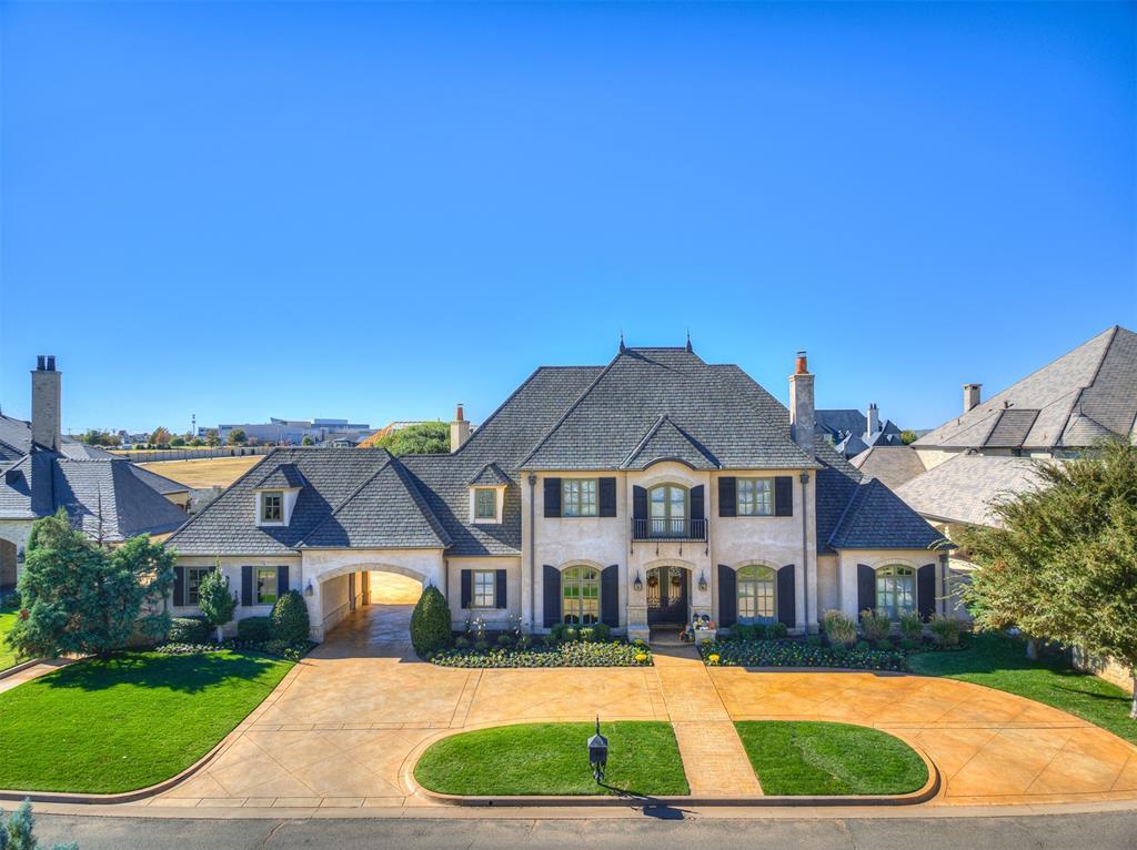 french country home featuring a front lawn