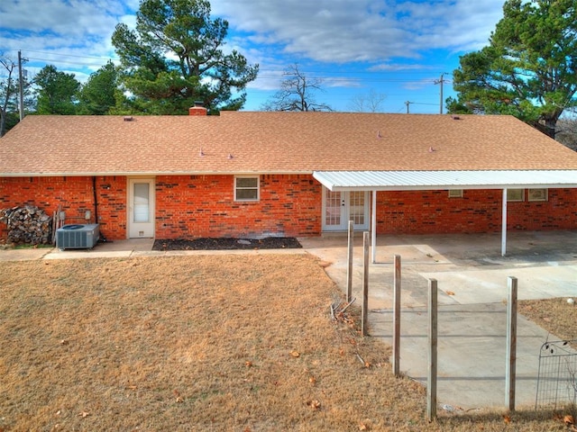 rear view of property featuring central AC